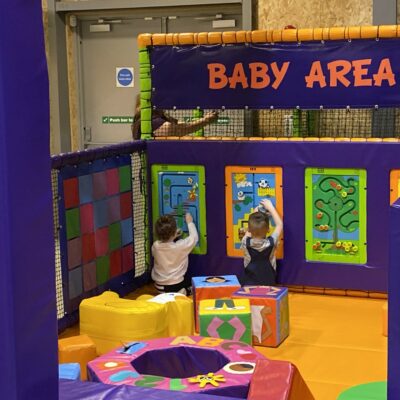 Two little toddlers playing in a colourful babies soft play area at High Rise Lisburn