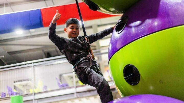 Young boy giving thumbs up on Astroball Climb and Climb challenge at High Rise Lisburn min