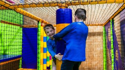 Young boys playing on the spinner in the soft play area at High Rise Lisburn min