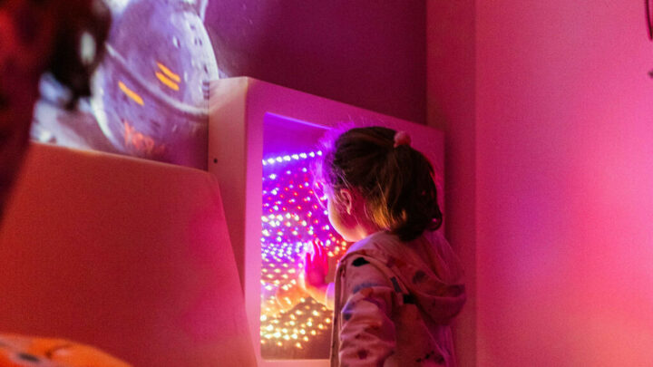 Young girl playing with the light box in the sensory rooms at High Rise Lisburn min