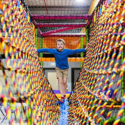 Young boy coming over the bridge in the soft play area at High Rise Lisburn