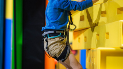 Young boy smiling at the camera while on a climbing challenge at High Rise Lisburn