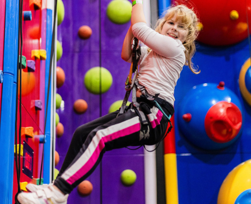 Young girl smiling on climbing walls at High Rise Lisburn (1)