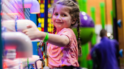 Young girl smiling on climbing walls at High Rise Lisburn